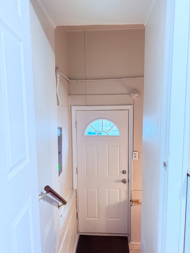 doorway to outside featuring ornamental molding