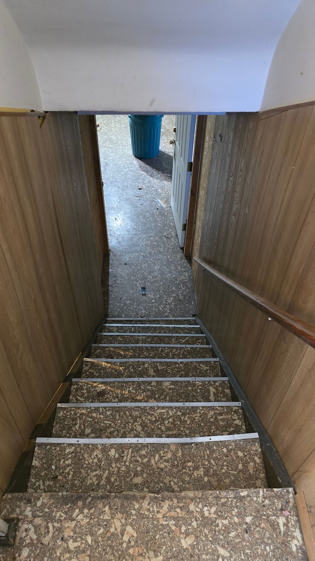 stairs with wood walls