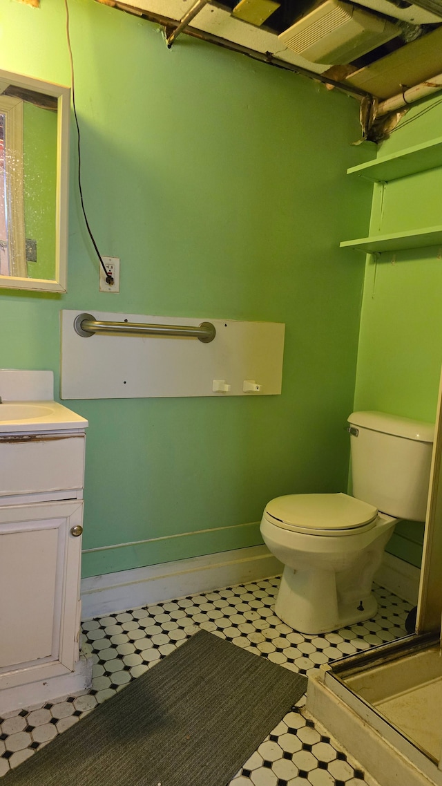 bathroom featuring vanity and toilet