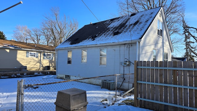 view of snow covered exterior featuring central air condition unit