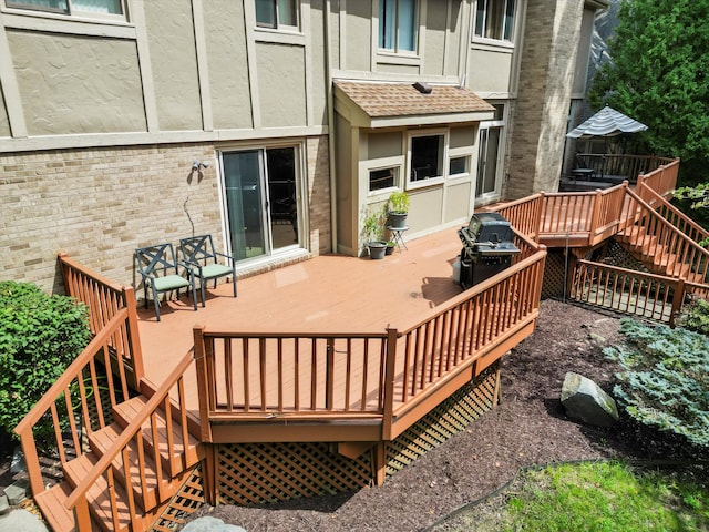 wooden terrace featuring area for grilling