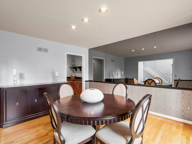 dining space with light hardwood / wood-style flooring