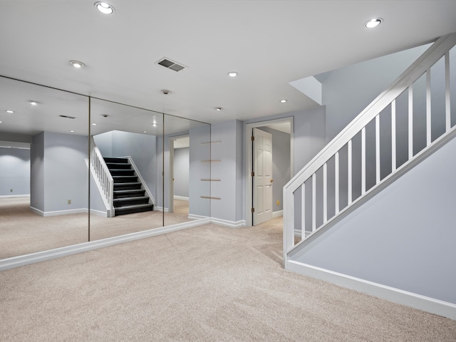 basement featuring light colored carpet