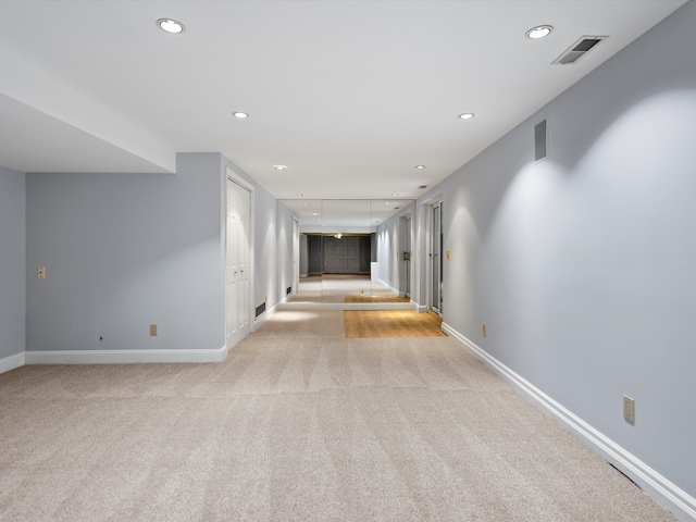 hall with light colored carpet