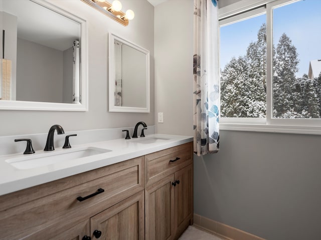 bathroom with plenty of natural light and vanity