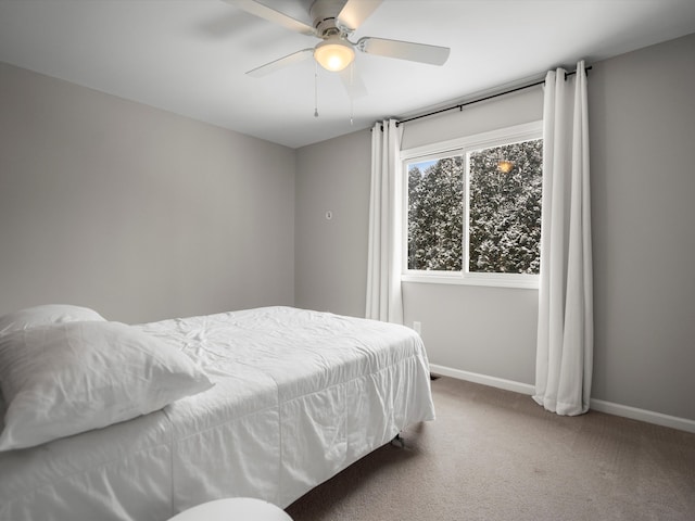 bedroom featuring ceiling fan and carpet