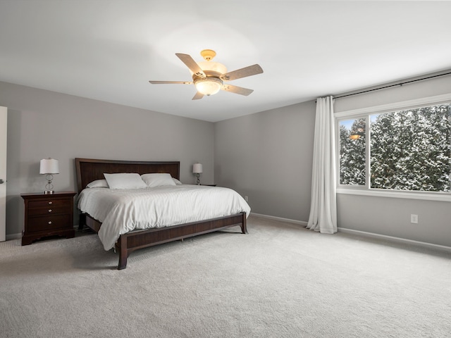 bedroom with ceiling fan and light carpet