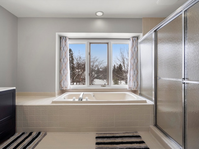 bathroom with tile patterned flooring, shower with separate bathtub, and vanity