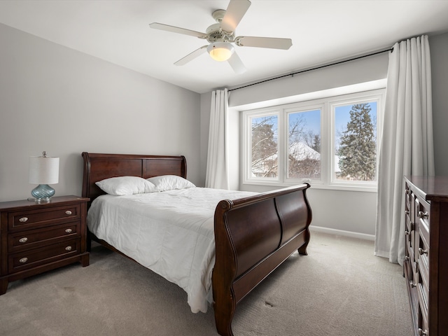 bedroom with ceiling fan and light carpet