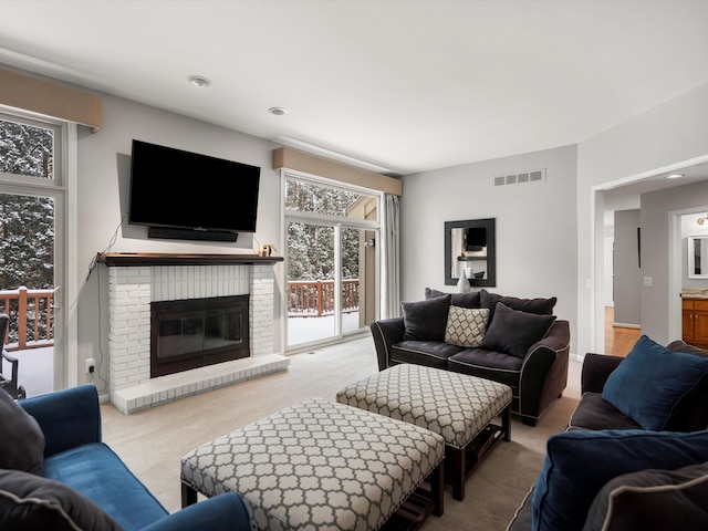 carpeted living room with a fireplace