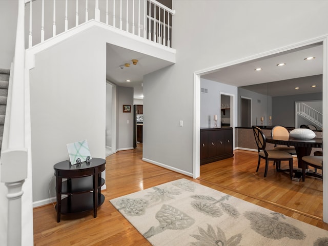 interior space featuring hardwood / wood-style floors and a towering ceiling