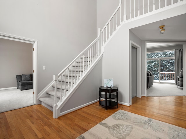 stairs featuring hardwood / wood-style floors