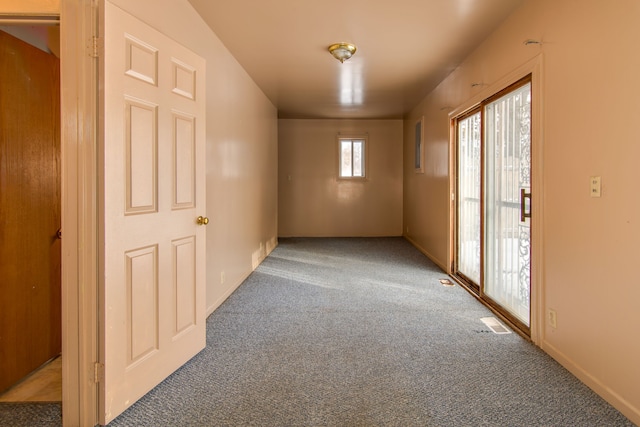 unfurnished room with a healthy amount of sunlight and carpet