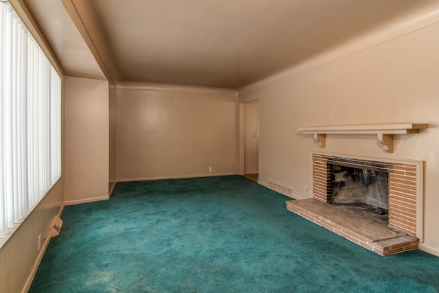 unfurnished living room with dark carpet and a fireplace