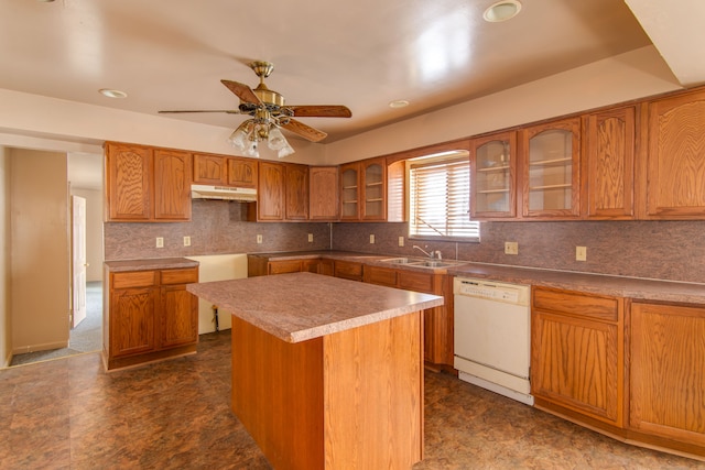 kitchen with white dishwasher, sink, a center island, and ceiling fan