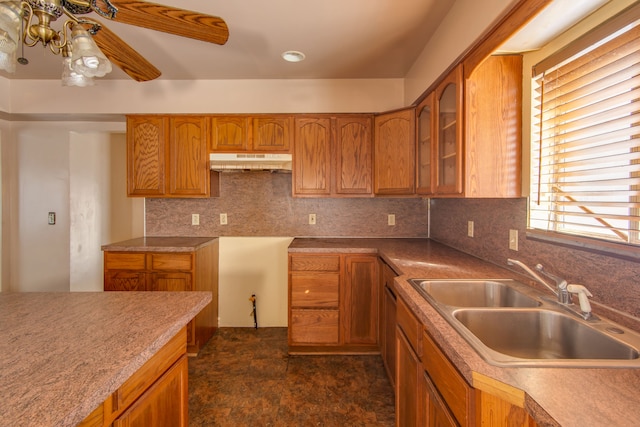 kitchen with a healthy amount of sunlight, sink, backsplash, and ceiling fan