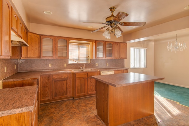 kitchen featuring hanging light fixtures, a wealth of natural light, a center island, and sink