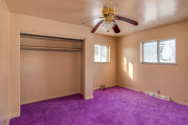 unfurnished bedroom featuring a closet, ceiling fan, and carpet