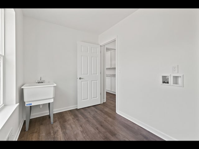 laundry area featuring dark hardwood / wood-style floors and washer hookup