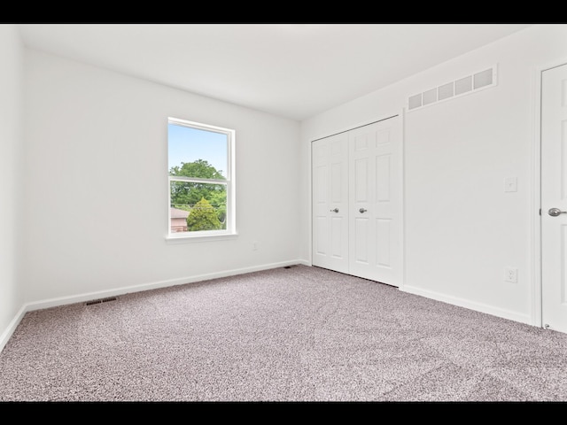 unfurnished bedroom with carpet floors and a closet