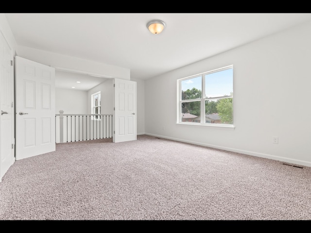 unfurnished room featuring carpet