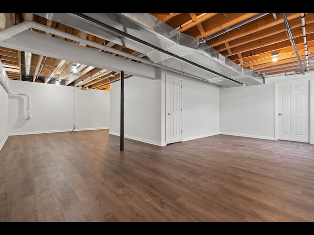 basement featuring dark hardwood / wood-style floors