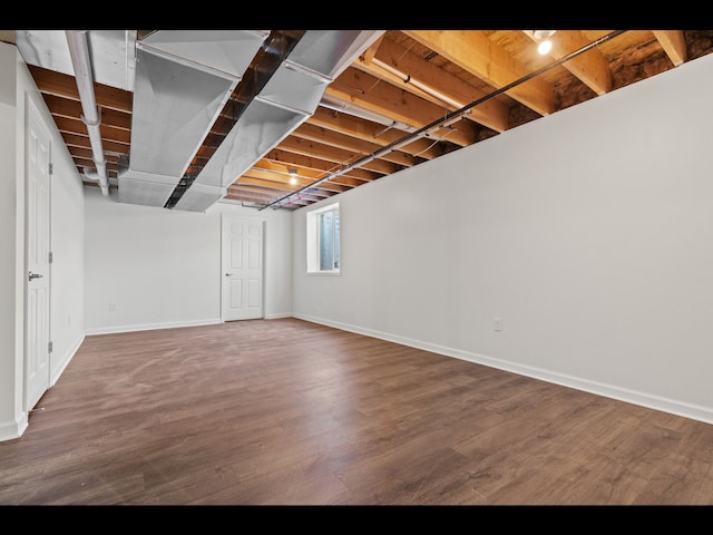 basement with hardwood / wood-style flooring