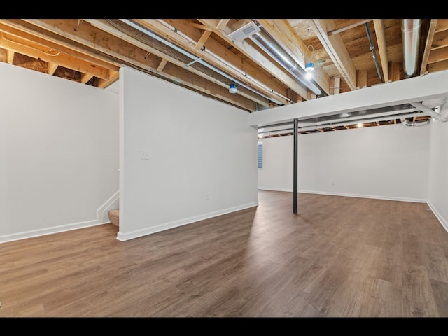 basement with hardwood / wood-style flooring