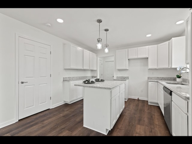 kitchen with white cabinetry, stainless steel dishwasher, a kitchen island, and pendant lighting