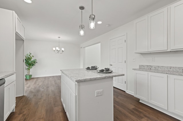 kitchen with pendant lighting, light stone countertops, and white cabinets