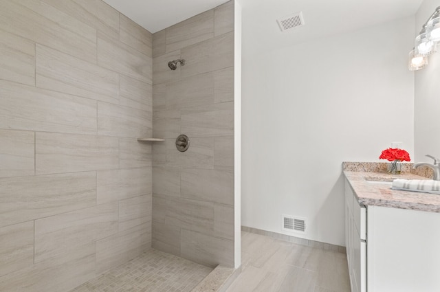 bathroom featuring vanity and a tile shower