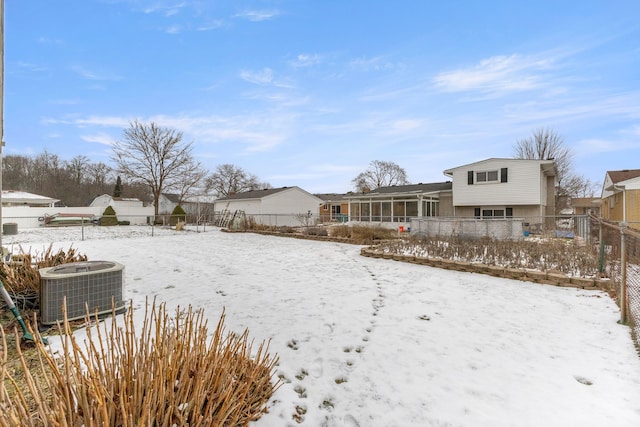 snowy yard with central AC unit