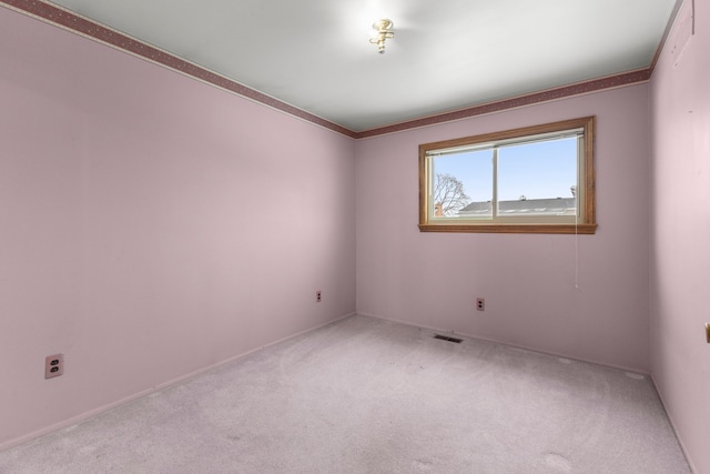 carpeted spare room with crown molding