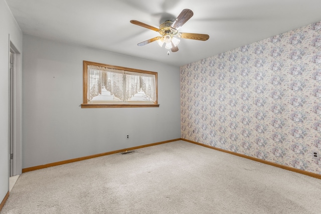 empty room with ceiling fan and light colored carpet