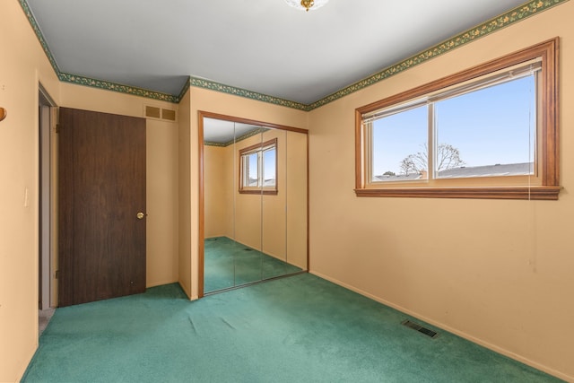 unfurnished bedroom featuring carpet and a closet