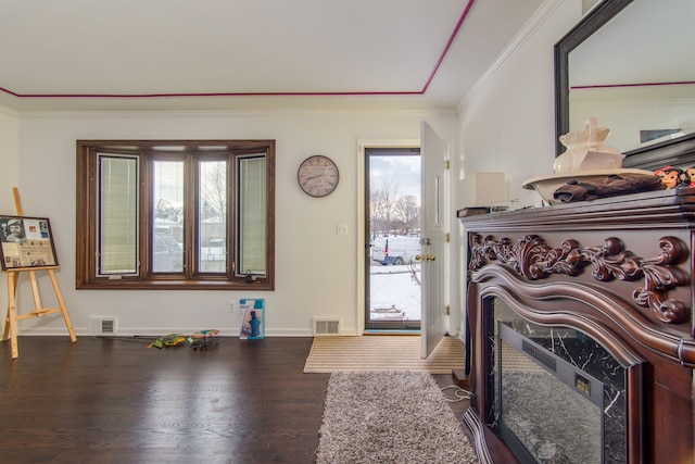 entrance foyer featuring crown molding and dark wood-type flooring