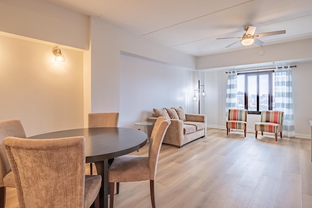 dining area featuring ceiling fan and wood-type flooring