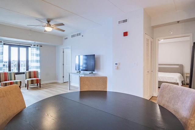 dining room with light hardwood / wood-style floors and ceiling fan