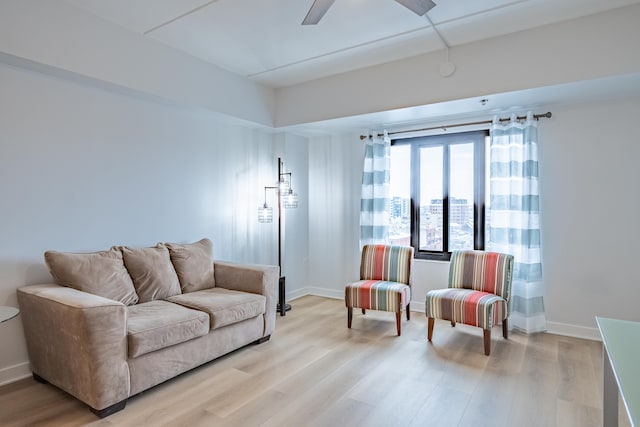 living room featuring ceiling fan and light hardwood / wood-style floors