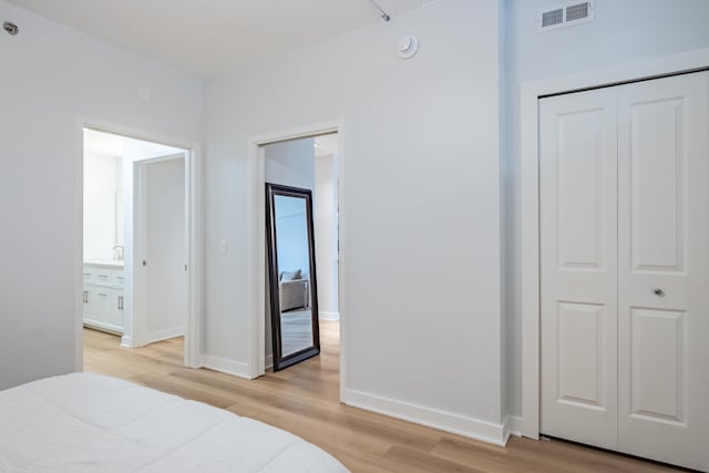 bedroom featuring light wood-type flooring and a closet