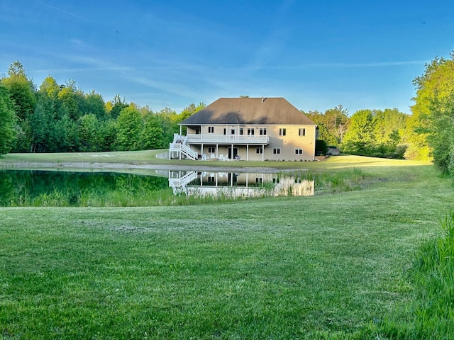 1084 38th St, Allegan, MI 49010 - rear view of house with a deck with water view and a lawn
