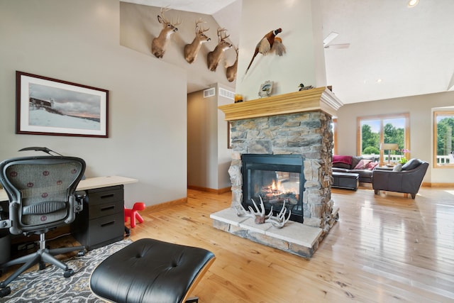 1084 38th St, Allegan, MI 49010 - living room with a fireplace, high vaulted ceiling, and light hardwood / wood-style flooring