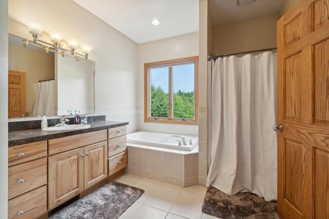 1084 38th St, Allegan, MI 49010 - bathroom featuring vanity, tiled bath, and tile patterned flooring