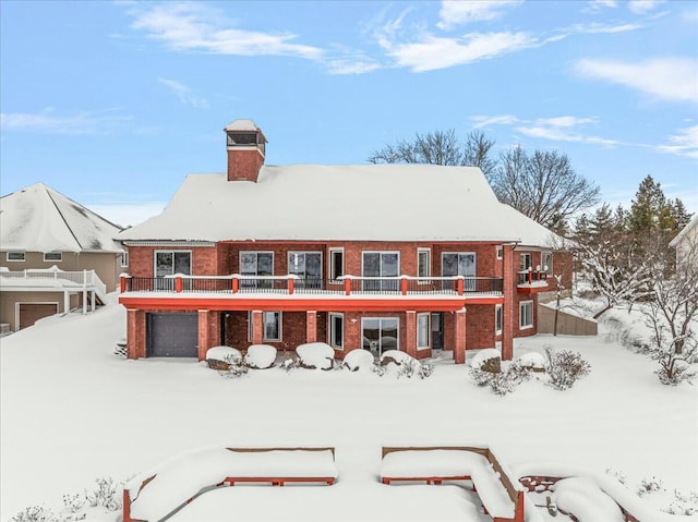 snow covered property with a balcony