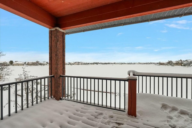 snow covered patio with a balcony