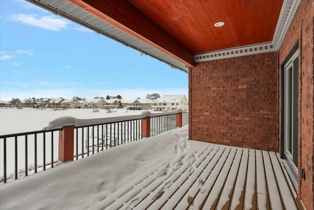 view of snow covered back of property