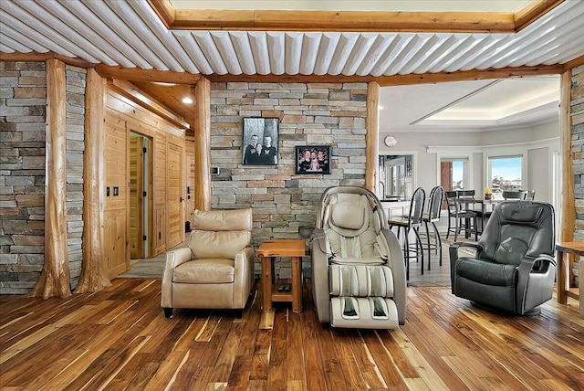 living area with wood-type flooring and beam ceiling