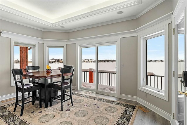 dining space featuring hardwood / wood-style flooring and ornamental molding