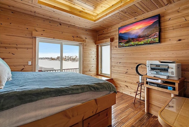 bedroom featuring hardwood / wood-style floors, access to outside, wooden ceiling, and wood walls