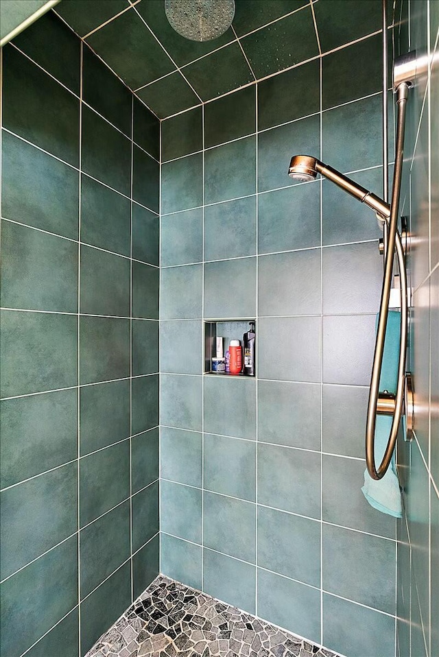 bathroom with tiled shower